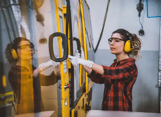 A woman receiving worker training on the job.